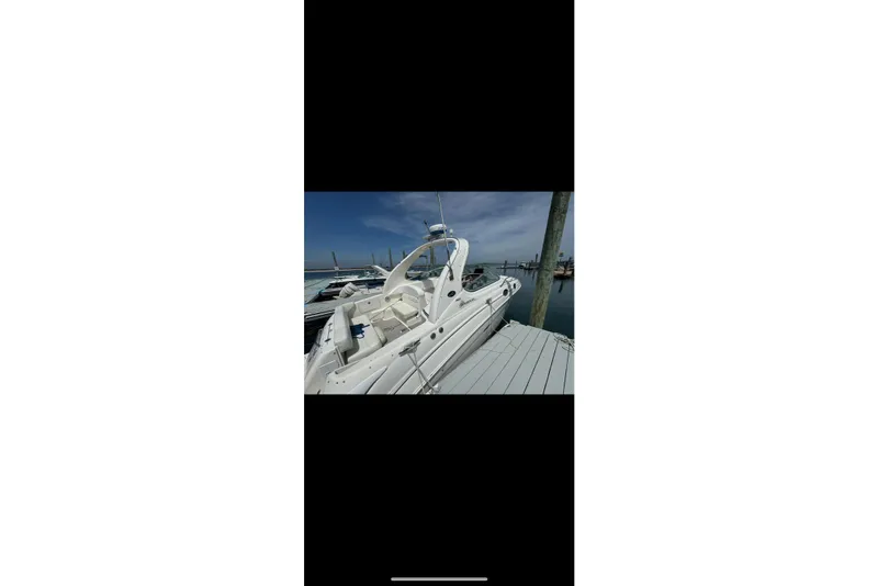 Slide: The Image of 2002 Sea Ray Sundancer 280 docked at marina under clear blue sky. - 8