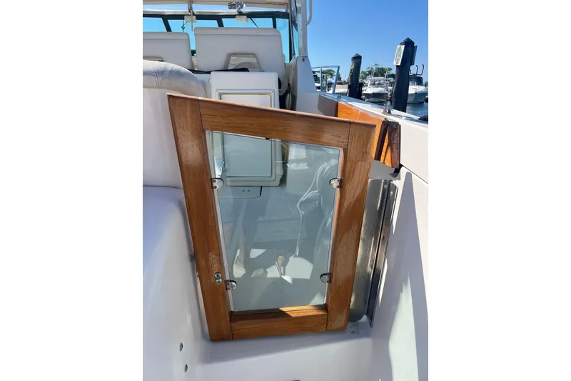 Slide: The Image of Wood-framed glass door on 1996 Tiara Yachts 3500 Express boat, docked in marina. - 10