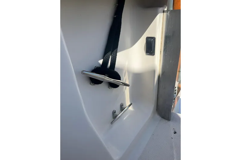 Slide: The Image of 1996 Tiara Yachts 3500 Express boat cleat and strap detail. - 11