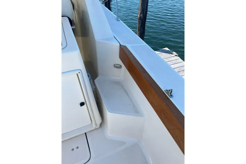 Slide: The Image of 1996 Tiara Yachts 3500 Express boat deck with wooden trim and water view. - 15