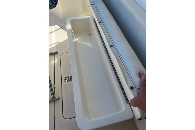 Slide: The Image of 1996 Tiara Yachts 3500 Express storage compartment with open lid. - 17
