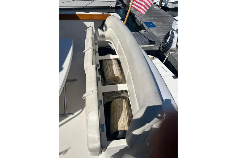 Slide: The Image of 1996 Tiara Yachts 3500 Express boat seating area with dock view. - 18