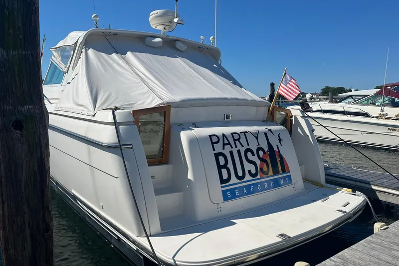 Slide: The Image of 1996 Tiara Yachts 3500 Express docked, featuring "Party Bus" sign, Seaford, NY. - 2