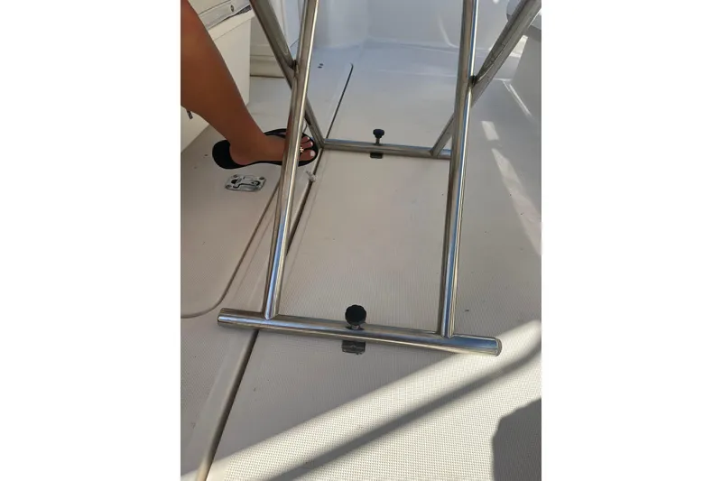 Slide: The Image of 1996 Tiara Yachts 3500 Express deck with stainless steel railing and foot in black sandal. - 20