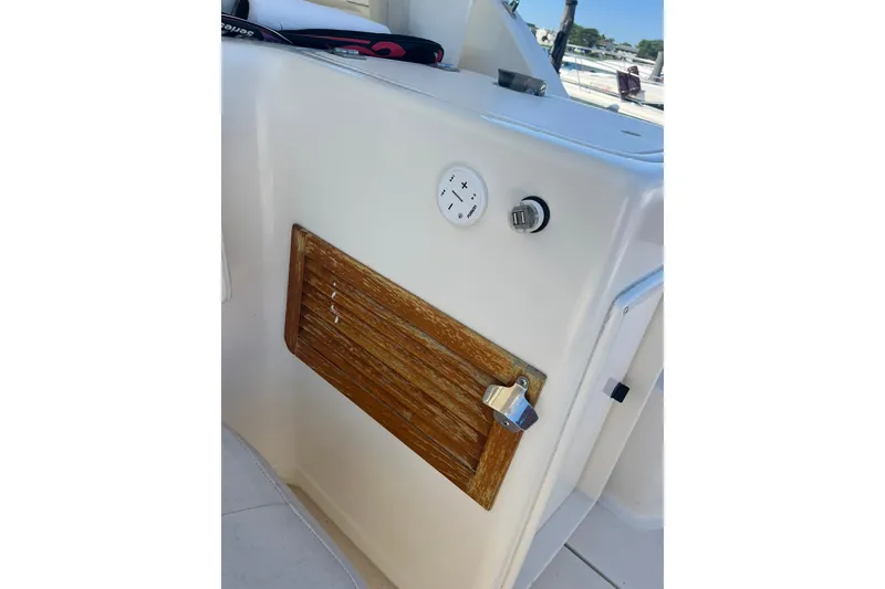 Slide: The Image of 1996 Tiara Yachts 3500 Express interior detail with wooden panel and control features. - 25