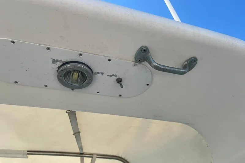 Slide: The Image of 1996 Tiara Yachts 3500 Express boat detail with light and handle against blue sky. - 27
