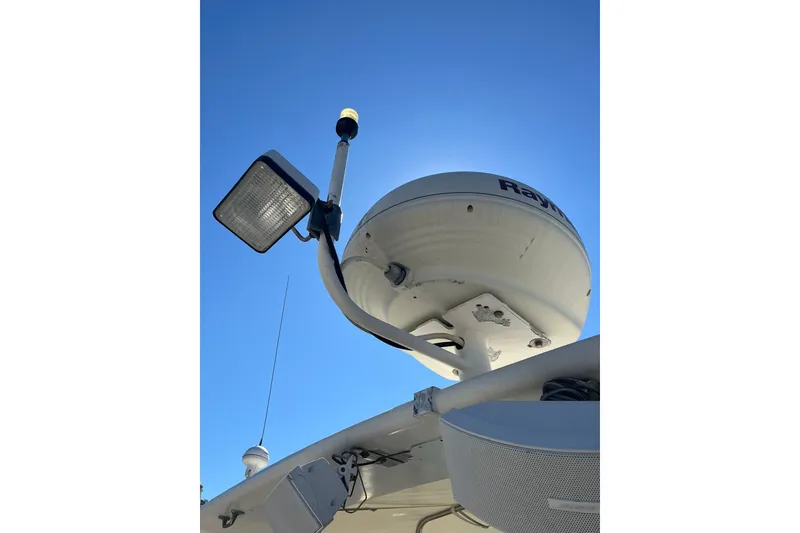 Slide: The Image of Radar and light equipment on a 1996 Tiara Yachts 3500 Express against a clear blue sky. - 28