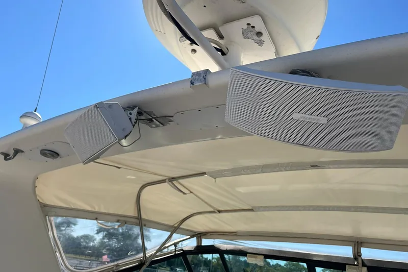 Slide: The Image of Speakers mounted on a 1996 Tiara Yachts 3500 Express, under a canopy with a clear sky. - 29