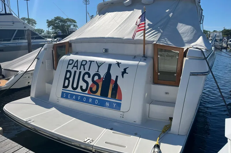 Slide: The Image of 1996 Tiara Yachts 3500 Express docked, featuring "Party Bus" signage, Seaford, NY. - 3