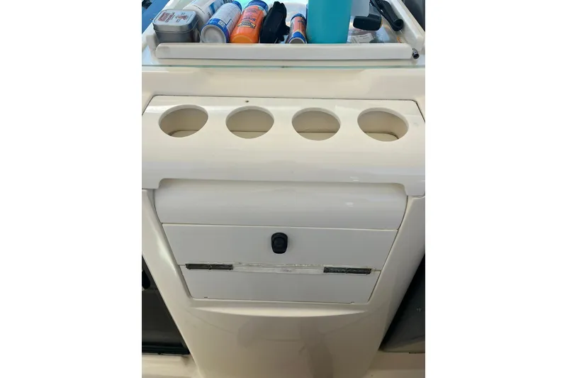Slide: The Image of Cup holders and storage on a 1996 Tiara Yachts 3500 Express boat. - 36