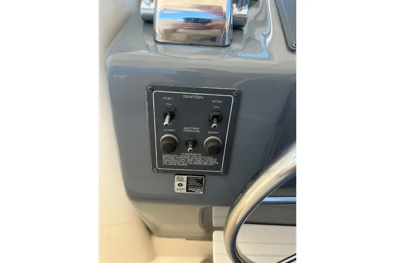 Slide: The Image of 1996 Tiara Yachts 3500 Express ignition panel with controls and warning label. - 37