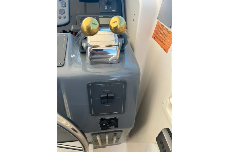 Slide: The Image of Control panel of a 1996 Tiara Yachts 3500 Express with throttle levers. - 39