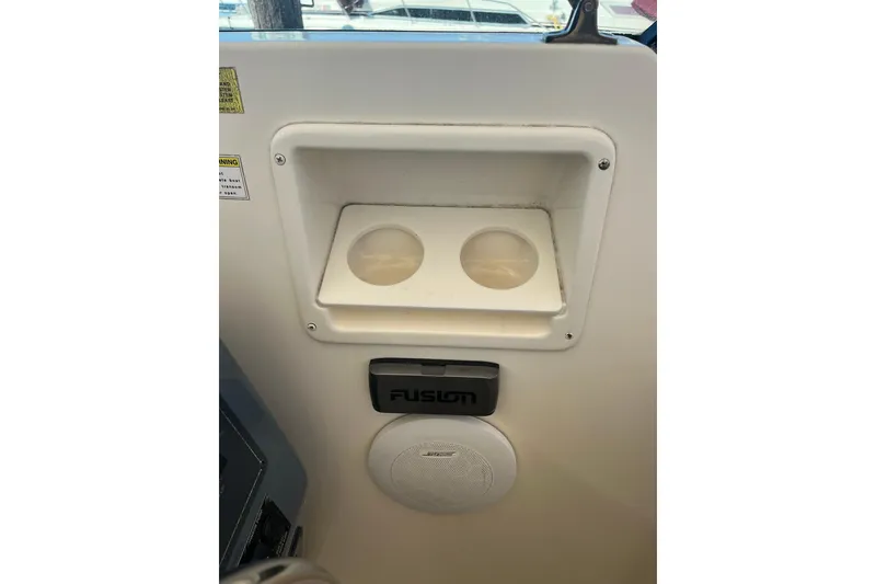 Slide: The Image of Cup holders and speaker on 1996 Tiara Yachts 3500 Express dashboard. - 42