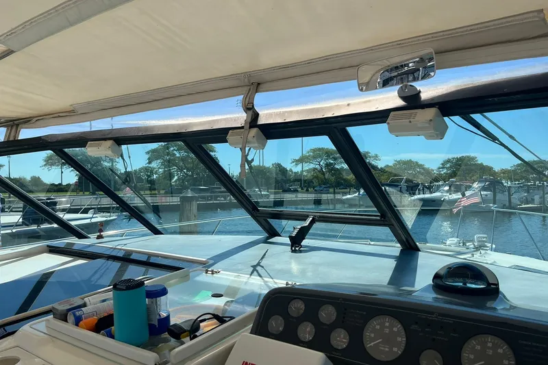 Slide: The Image of Interior view of 1996 Tiara Yachts 3500 Express, showcasing helm and marina scenery. - 43