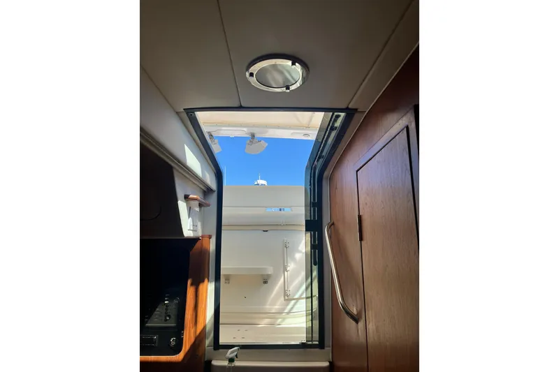 Slide: The Image of Interior view of 1996 Tiara Yachts 3500 Express, showcasing cabin entrance and natural light. - 49