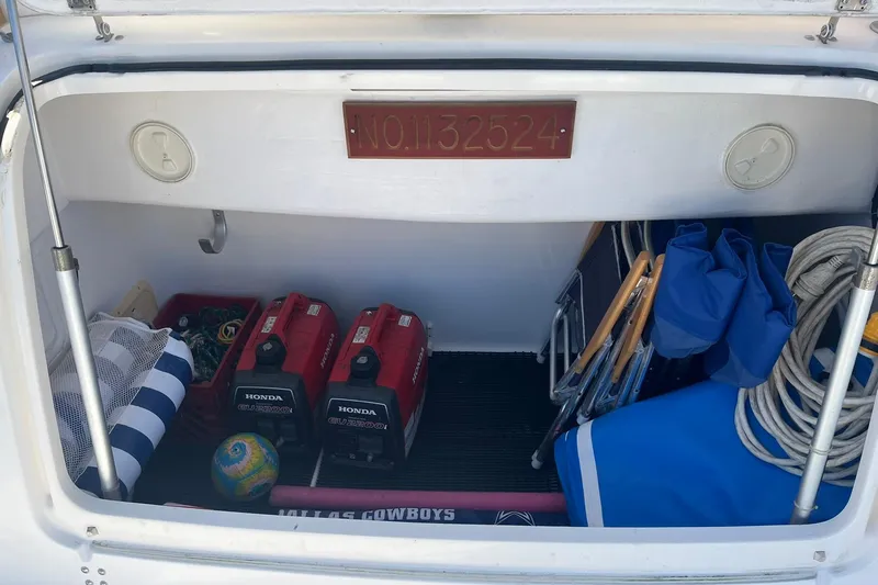Slide: The Image of Storage compartment of a 1996 Tiara Yachts 3500 Express with Honda generators and boating gear. - 5