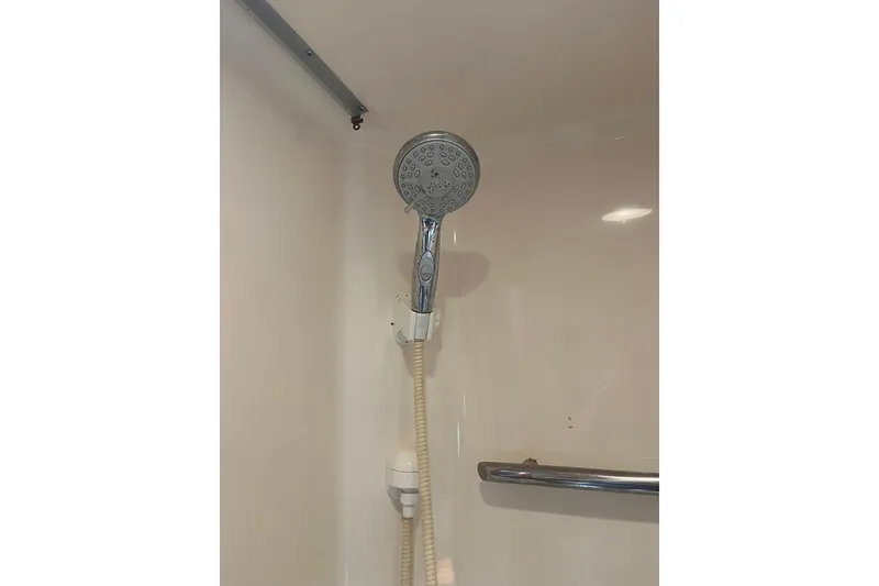 Slide: The Image of Shower area in 1996 Tiara Yachts 3500 Express, featuring a handheld showerhead. - 55