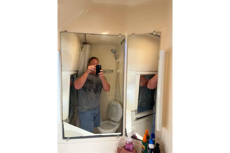 Slide: The Image of Man taking a selfie in a yacht bathroom mirror, Tiara Yachts 3500 Express, 1996. - 56
