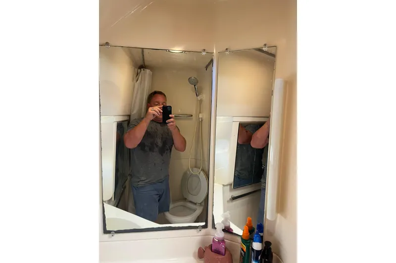 Slide: The Image of Man taking a selfie in a Tiara Yachts 3500 Express 1996 bathroom mirror. - 57