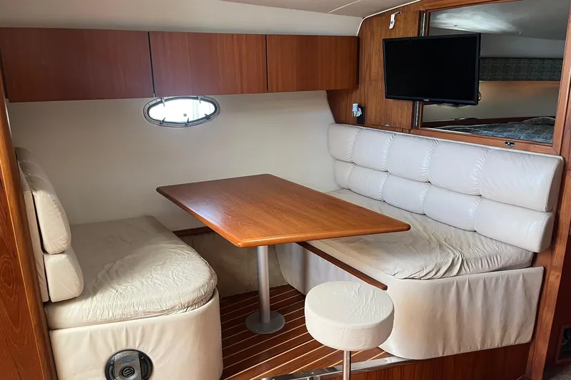 Slide: The Image of 1996 Tiara Yachts 3500 Express cabin interior with dining area and TV. - 60