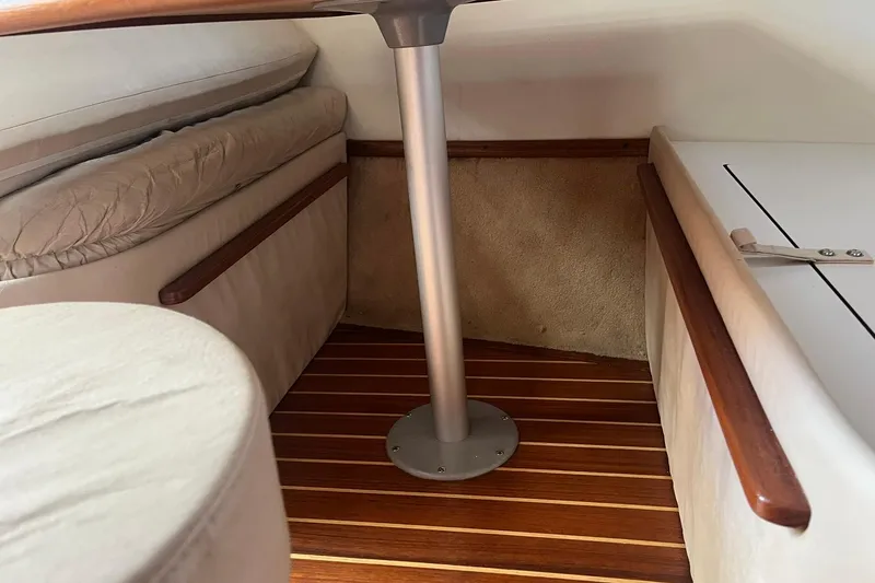 Slide: The Image of Interior of 1996 Tiara Yachts 3500 Express with wooden flooring and cushioned seating. - 66