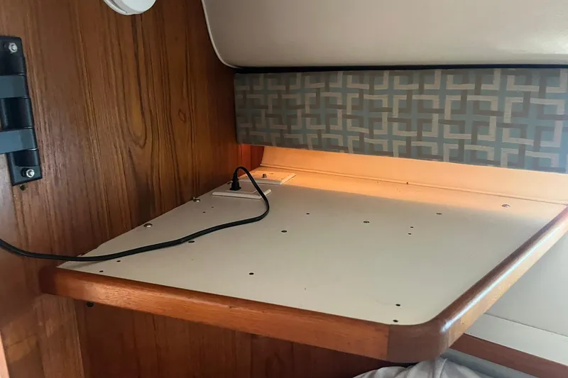 Slide: The Image of Interior of 1996 Tiara Yachts 3500 Express with wooden paneling and patterned upholstery. - 69