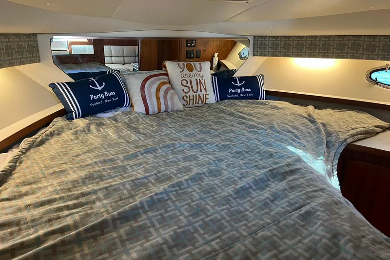 Slide: The Image of Cozy cabin interior of 1996 Tiara Yachts 3500 Express with decorative pillows and bedding. - 71