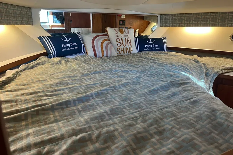 Slide: The Image of Cozy cabin interior of 1996 Tiara Yachts 3500 Express with decorative pillows and bedding. - 72