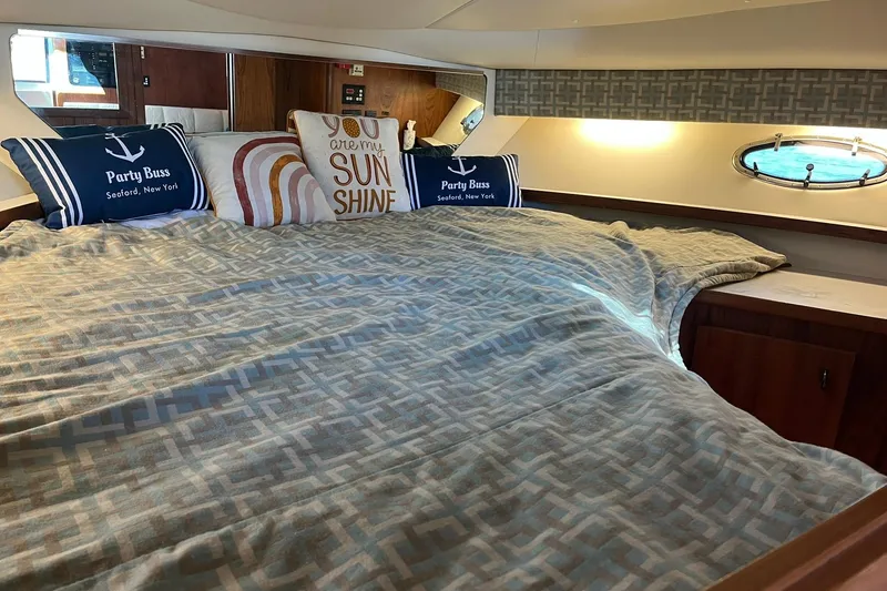 Slide: The Image of Cozy cabin interior of 1996 Tiara Yachts 3500 Express with decorative pillows and bedding. - 73