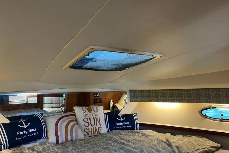 Slide: The Image of Interior of 1996 Tiara Yachts 3500 Express with cozy bedding and decorative pillows. - 74