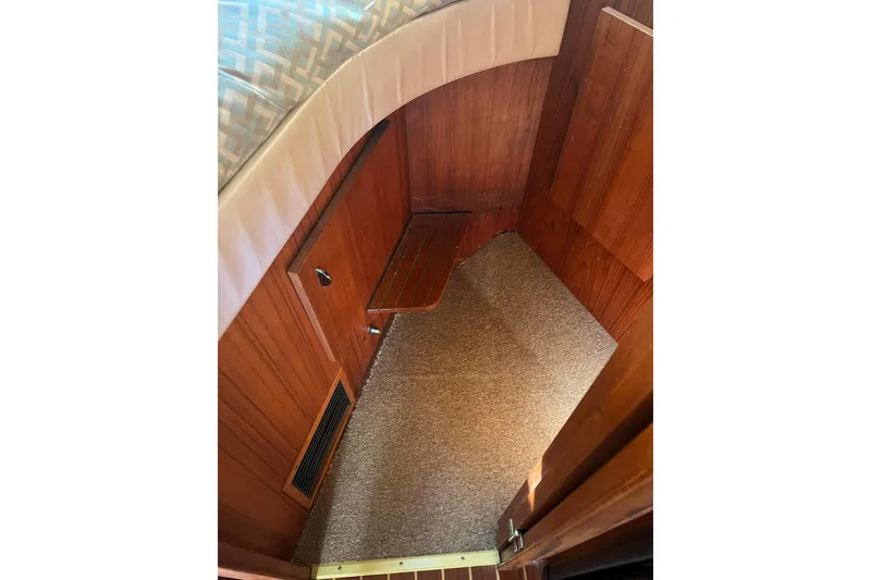 Slide: The Image of Interior cabin of 1996 Tiara Yachts 3500 Express with wood paneling and carpeted floor. - 75