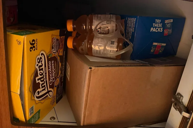 Slide: The Image of Storage cabinet on a 1996 Tiara Yachts 3500 Express with snacks and drinks. - 76