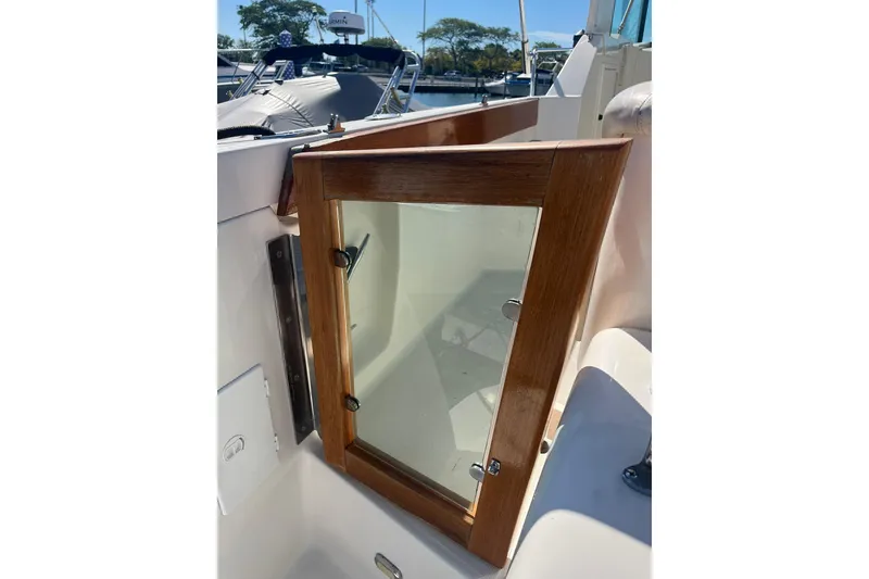 Slide: The Image of Wood-framed glass door on 1996 Tiara Yachts 3500 Express, showcasing elegant marine craftsmanship. - 8