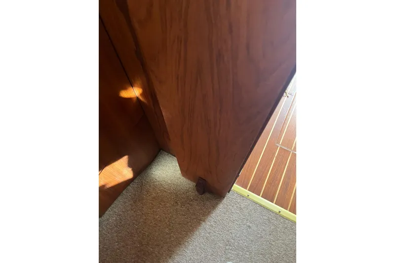 Slide: The Image of Interior view of 1996 Tiara Yachts 3500 Express, featuring wooden paneling and carpet flooring. - 80