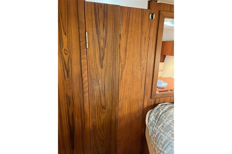 Slide: The Image of Wooden interior of a 1996 Tiara Yachts 3500 Express, showcasing cabin details. - 81