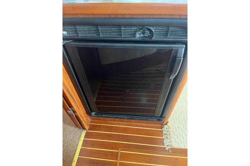 Slide: The Image of 1996 Tiara Yachts 3500 Express interior fridge with wooden flooring. - 82