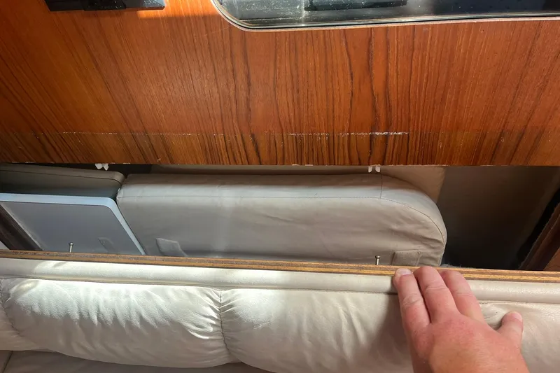 Slide: The Image of Interior view of a 1996 Tiara Yachts 3500 Express, showcasing wooden paneling and seating. - 88