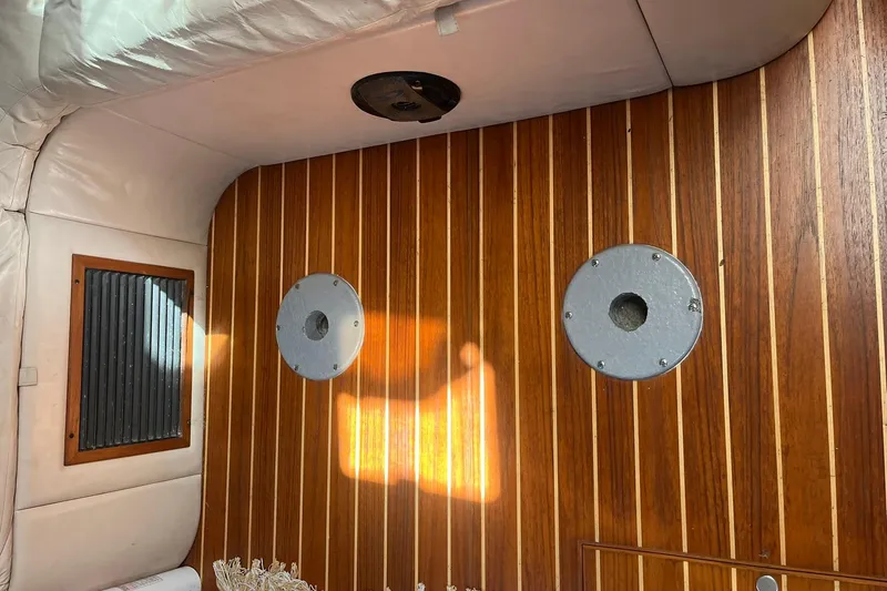Slide: The Image of Interior of 1996 Tiara Yachts 3500 Express with wood paneling and circular fixtures. - 89
