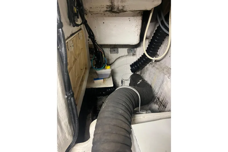 Slide: The Image of Engine compartment of a 1996 Tiara Yachts 3500 Express, showing hoses and wiring. - 93