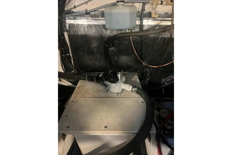 Slide: The Image of Engine compartment of a 1996 Tiara Yachts 3500 Express, showing mechanical components and wiring. - 94