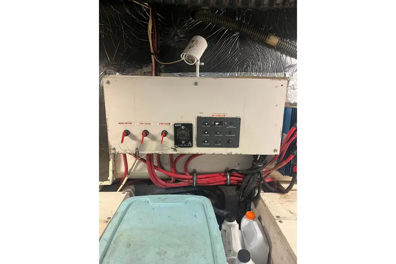 Slide: The Image of Electrical panel of a 1996 Tiara Yachts 3500 Express with labeled switches and wiring. - 96
