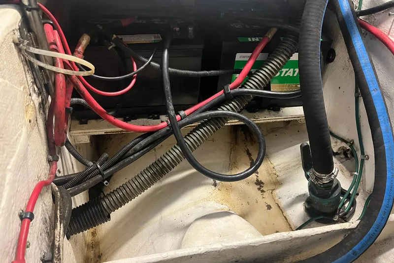 Slide: The Image of Engine compartment of a 1996 Tiara Yachts 3500 Express, showing wiring and battery setup. - 97