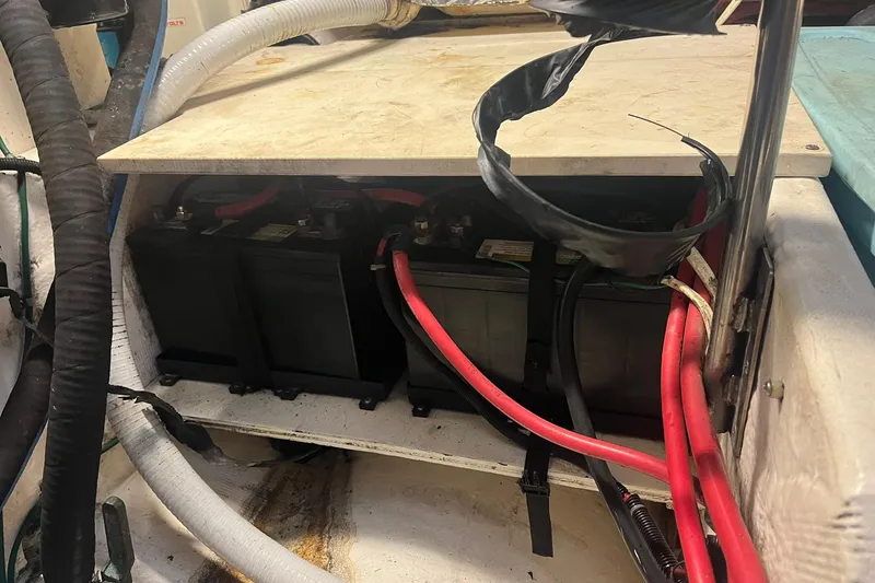 Slide: The Image of Battery compartment of a 1996 Tiara Yachts 3500 Express with visible cables and wiring. - 98