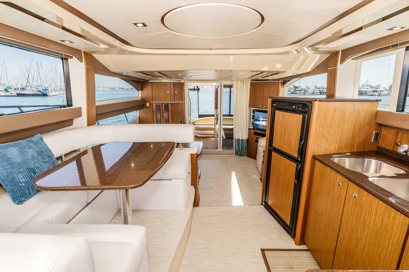 Slide: The Image of Luxurious interior of a 2016 Meridian 441 Sedan yacht with elegant furnishings and marina view. - 12