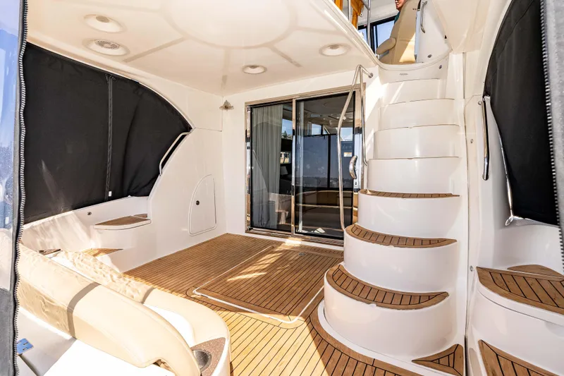 Slide: The Image of Luxurious 2016 Meridian 441 Sedan yacht interior with elegant wood flooring and curved staircase. - 22
