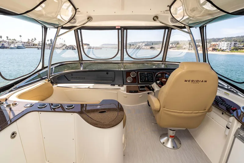 Slide: The Image of Interior view of 2016 Meridian 441 Sedan yacht cockpit with luxurious seating and panoramic windows. - 23