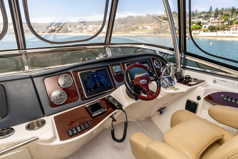 Slide: The Image of Helm of 2016 Meridian 441 Sedan yacht with modern controls and scenic waterfront view. - 24
