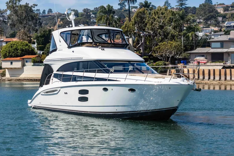Slide: The Image of 2016 Meridian 441 Sedan yacht cruising near waterfront homes. - 3