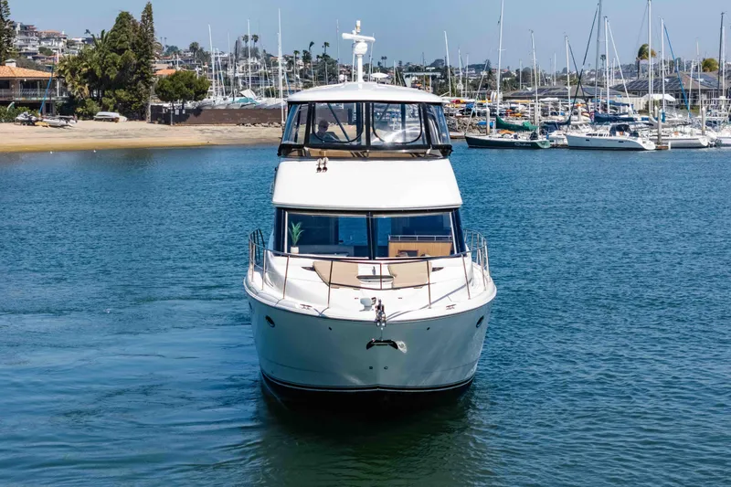 Slide: The Image of Front view of a 2016 Meridian 441 Sedan yacht on calm waters. - 4