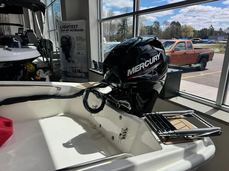 Slide: The Image of 2026 Boston Whaler 130 Super Sport with Mercury engine in showroom. - 10
